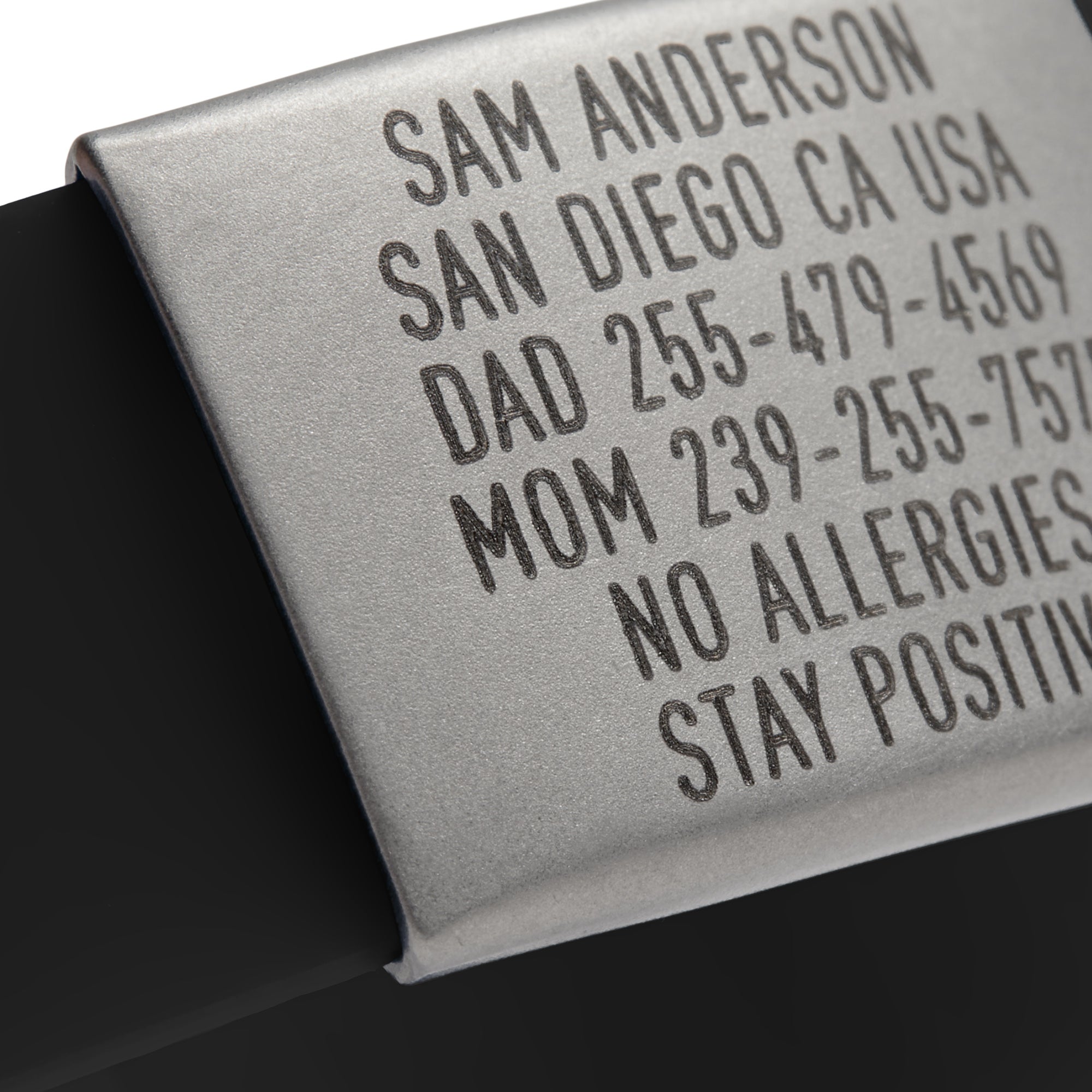 Close-up of a Black silicone and silver ID tag with matching silver double locking clasp emergency wristband by BRECK