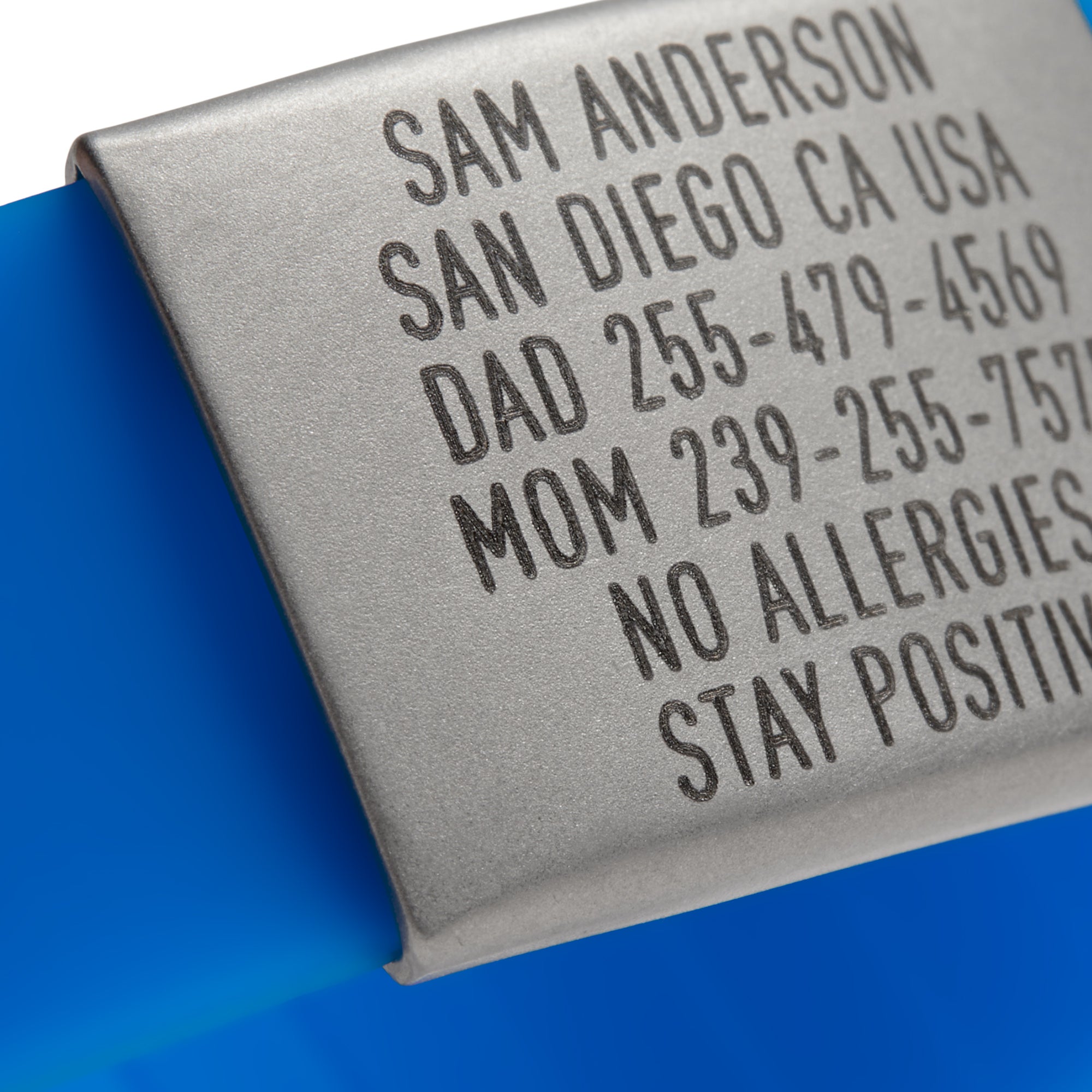 Close-up of a Blue silicone and silver ID tag with matching silver double locking clasp emergency wristband by BRECK