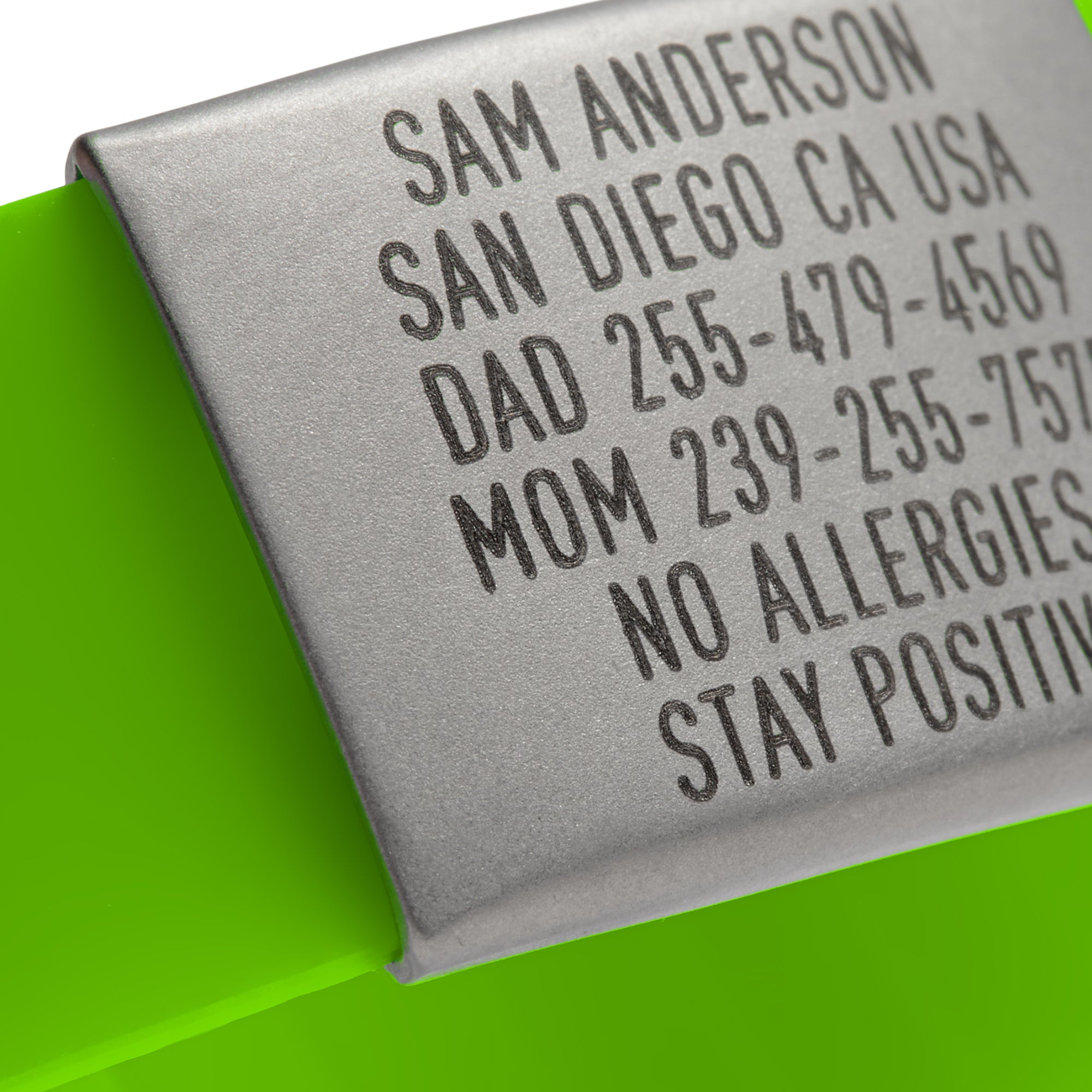 Close-up of a Lime Green silicone and silver ID tag with matching silver double locking clasp emergency wristband by BRECK