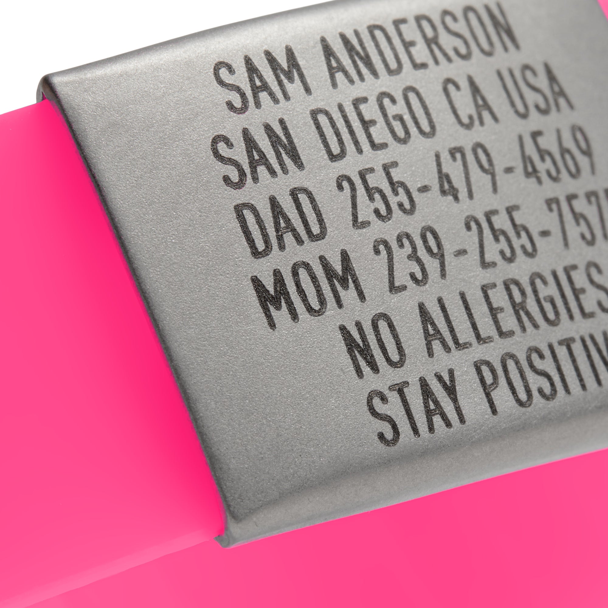 Close-up of a Pink silicone and silver ID tag with matching silver double locking clasp emergency wristband by BRECK