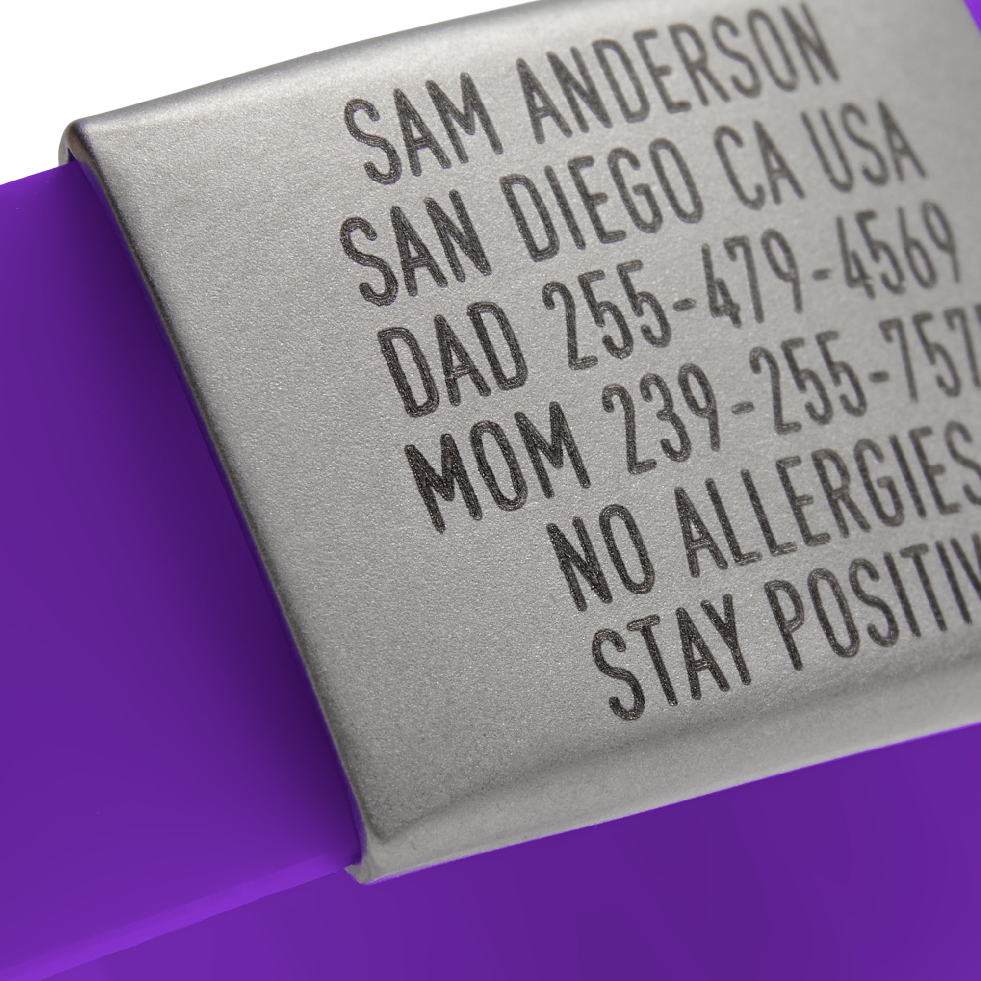 Close-up of a Purple silicone and silver ID tag with matching silver double locking clasp emergency wristband by BRECK